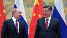 Russian President Vladimir Putin (L) and Chinese President Xi Jinping pose for a photograph during their meeting in Beijing, on February 4, 2022. 