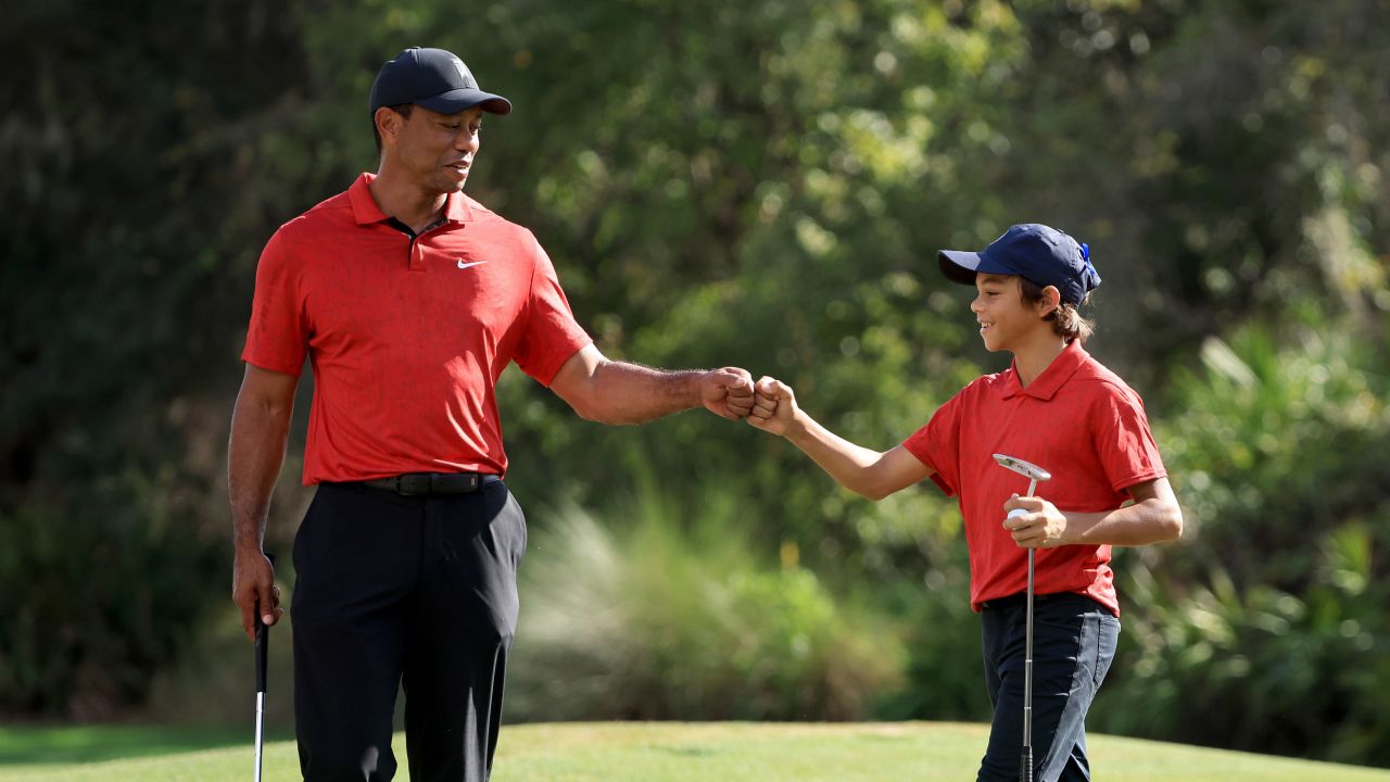 Woods and his son Charlie celebrate a birdie on the 12th hole during the final round of the PNC Championship.