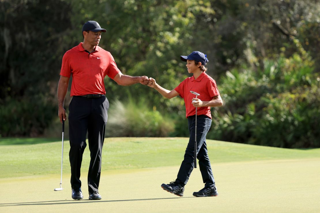 Woods and his son Charlie celebrate a birdie on the 12th hole during the final round of the PNC Championship.