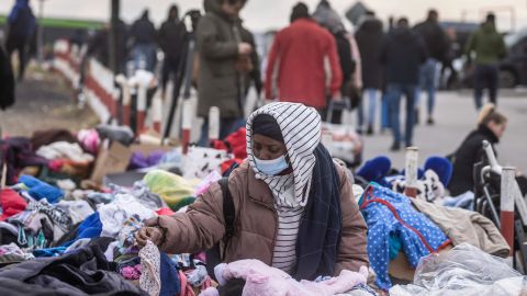 An African woman tries to find some clothes as refugees flee the conflict in Ukraine, on February 27, 2022. 