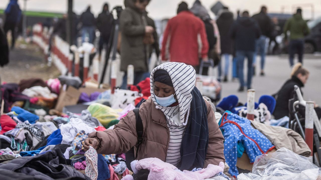 An African woman tries to find some clothes as refugees flee the conflict in Ukraine, on February 27, 2022. 