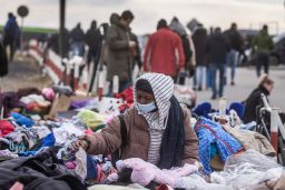 An African woman tries to find some clothes as refugees flee the conflict in Ukraine, on February 27, 2022. 