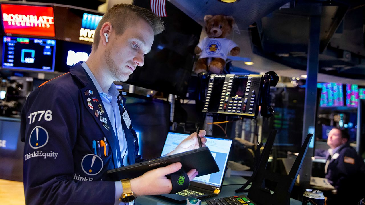 In this photo provided by the New York Stock Exchange, trader Colby Nelson works on the floor, Monday, Feb 28, 2022. Markets quivered Monday amid worries about how high oil prices will go and how badly the global economy will get hit after the U.S. and allies upped the financial pressure on Russia for its invasion of Ukraine.