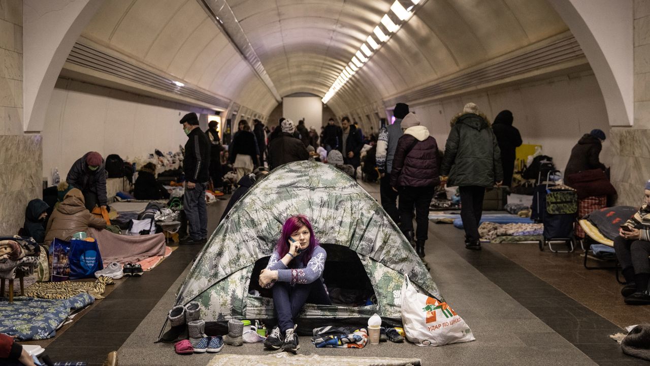 A woman sits in a tent as people take shelter in the Dorohozhychi subway station in Kyiv on Wednesday. 