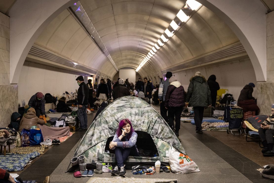 A woman sits in a tent as people take shelter in the Dorohozhychi subway station in Kyiv on Wednesday. 
