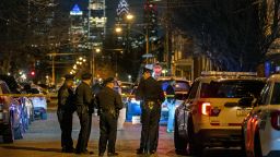 Police investigate the scene of a shooting on Tuesday, March 1, 2022 in Philadelphia.  An unidentified male teen was fatally shot by police and an officer was injured by shattered glass during a confrontation Tuesday night in South Philadelphia, police said.