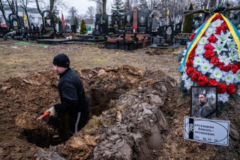 A cemetery worker digs graves for Ukrainian soldiers in Kyiv on March 3.