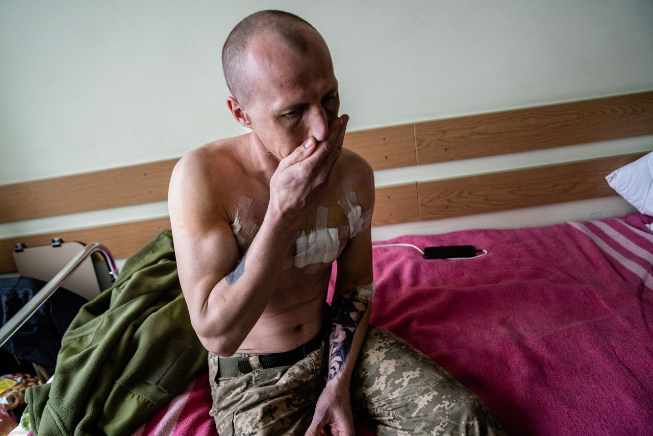 A Ukrainian soldier who says he was shot three times in the opening days of the invasion sits on a hospital bed in Kyiv on March 3.  Zelensky says Russia waging war so Putin can stay in power &#8216;until the end of his life&#8217; w 1280