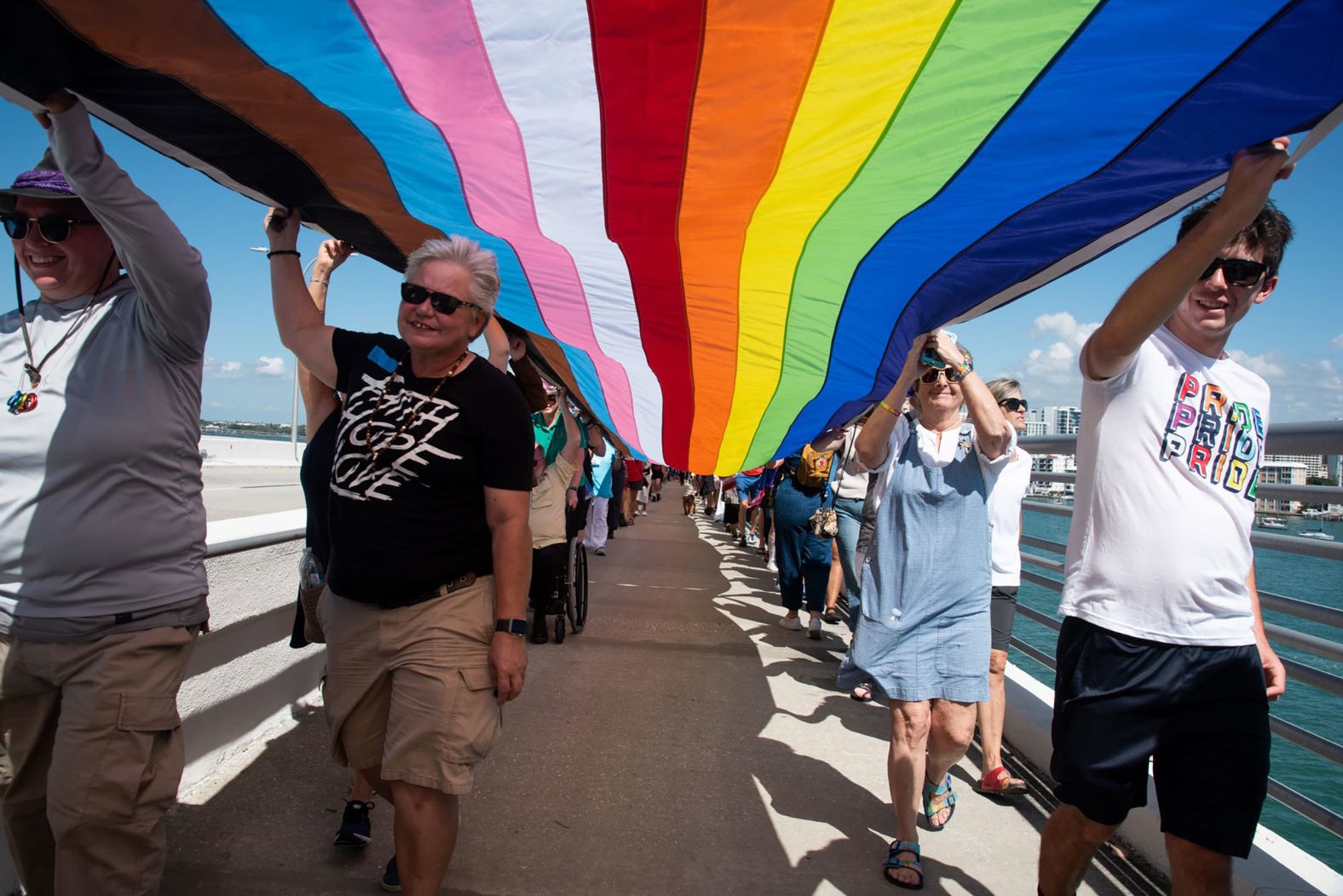 People hold a 700-foot rainbow flag over the Ringling Bridge in Sarasota, Florida, on Sunday, February 27. They were rallying against what some people are calling the <a href="index.php?page=&url=https%3A%2F%2Fwww.cnn.com%2F2022%2F02%2F13%2Fus%2Fdont-say-gay-bill-florida-lgbtq-youth-cec%2Findex.html" target="_blank">"Don't Say Gay" bill,</a> legislation that would ban school districts in the state from encouraging classroom discussions related to sexual orientation and gender identity.