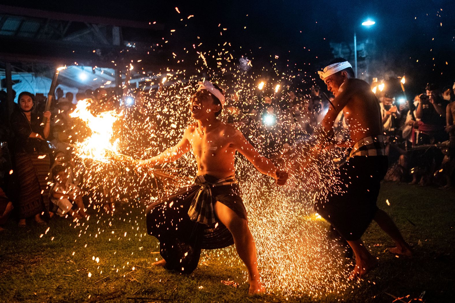 A man in the Indonesian village of Paksebali is hit with burning dried coconut leaves during a ritual called Lukad Gni on Wednesday, March 2.