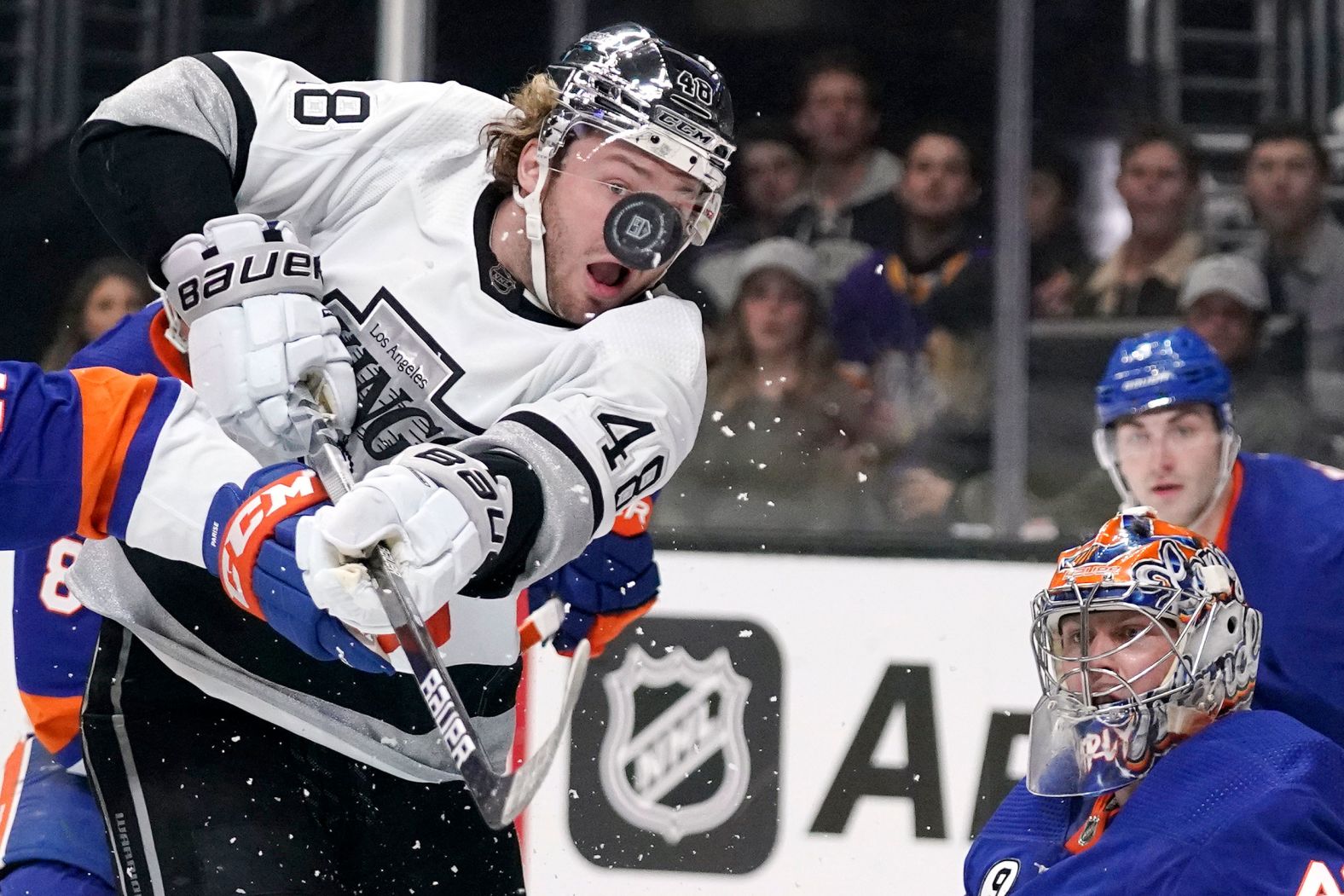 Los Angeles forward Brendan Lemieux, left, watches the puck after it deflected off New York Islanders goalie Semyon Varlamov during an NHL game on Saturday, February 26.