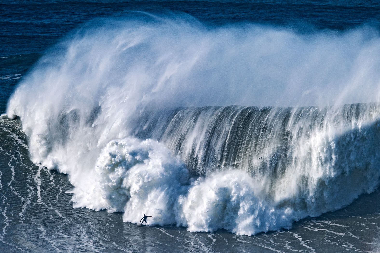 A surfer rides a huge wave in Nazare, Portugal, on Friday, February 25.
