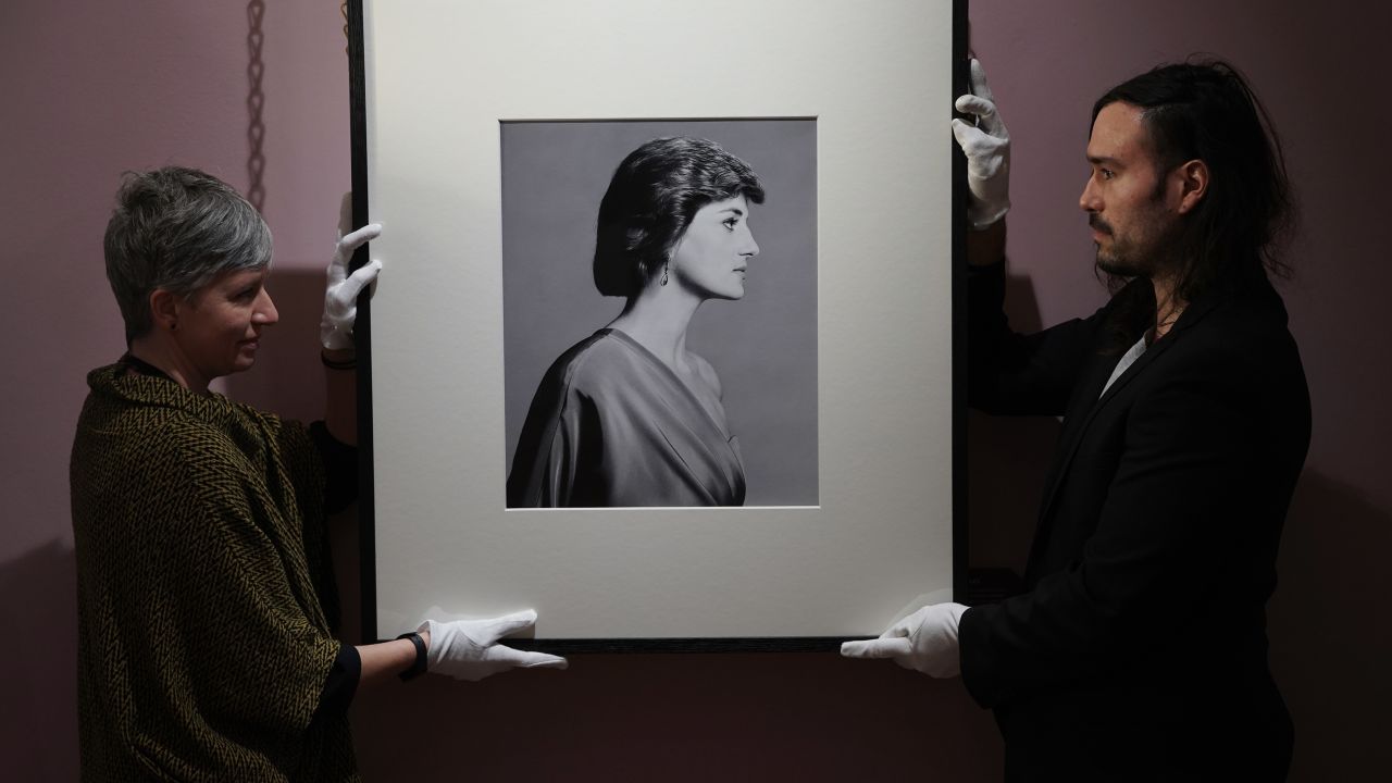 Conservators handle David Bailey's portrait of Diana.