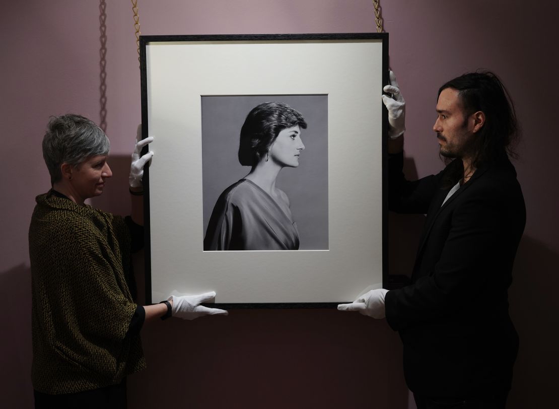 Conservators handle David Bailey's portrait of Diana.
