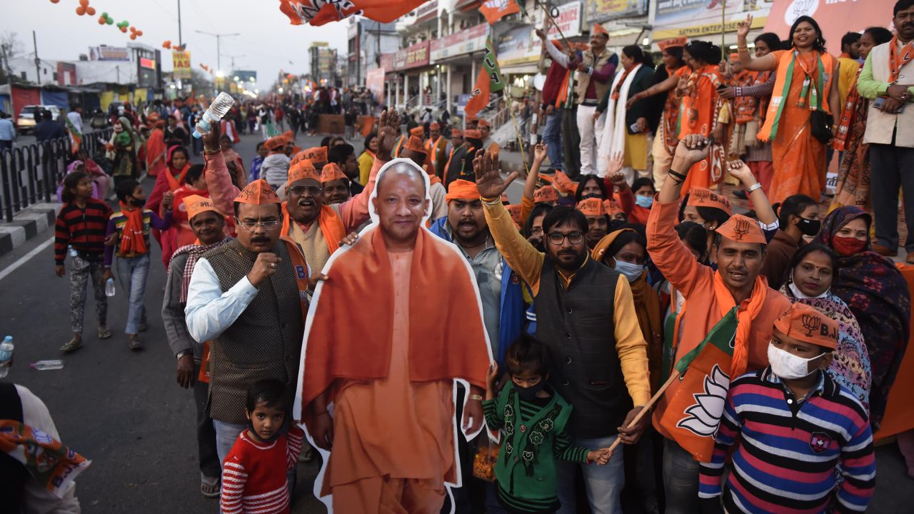 Bharatiya Janata Party (BJP) supporters carry a Yogi Adityanath cutout during an election campaign on February 20, 2022 in Lucknow, India. 
