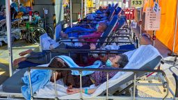 Covid-19 patients seen laying on beds outside the Caritas Medical Center in Hong Kong. Hong Kong hospitals are overwhelmed as the city is facing its worst-ever coronavirus outbreak. 