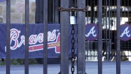 Locked gates are shown at Truist Park home of the Atlanta Braves baseball team Wednesday, March 2, 2022, in Atlanta. MLB commissioner Rob Manfred has canceled the first two series for each of the 30 teams, cutting each club's schedule from 162 games to likely 156 at most. 