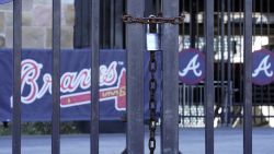 Locked gates are shown at Truist Park home of the Atlanta Braves baseball team Wednesday, March 2, 2022, in Atlanta. MLB commissioner Rob Manfred has canceled the first two series for each of the 30 teams, cutting each club's schedule from 162 games to likely 156 at most.