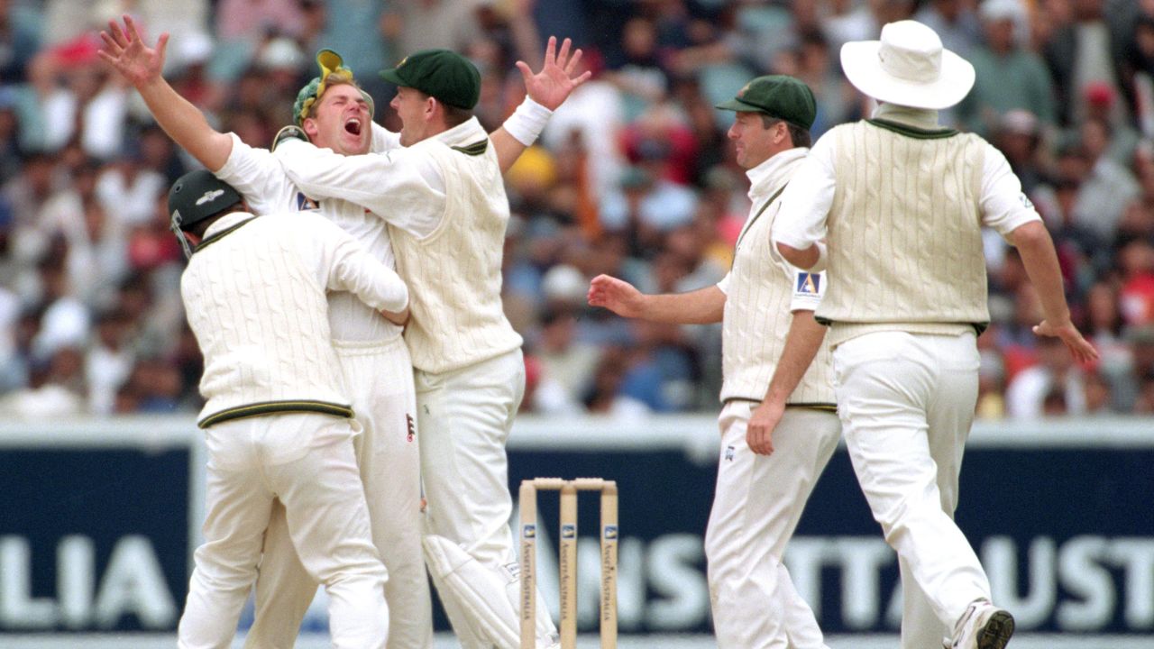 Warne celebrates with his teammates after taking the wicket Sachin Tendulkar in 1999.