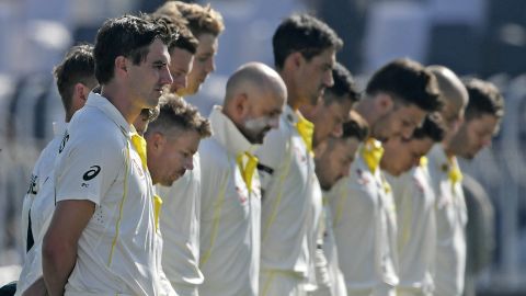 Australia's players observe a minute silence to pay tribute to Marsh before the start of the first day play of the first Test match between Pakistan and Australia on March 4.