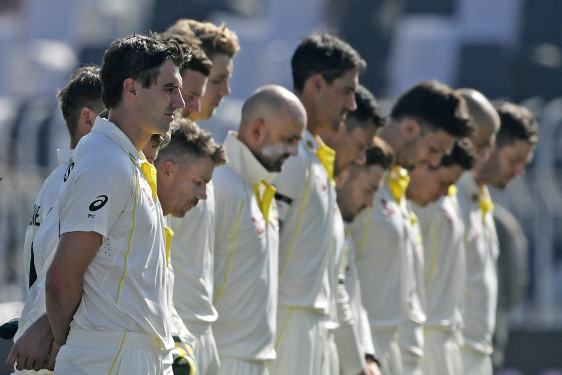 Australia's players observe a minute silence to pay tribute to Marsh before the start of the first day play of the first Test match between Pakistan and Australia on March 4.