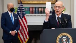 US Supreme Court Justice Stephen Breyer holds up a copy of the Constitution as he announces his retirement alongside US President Joe Biden (L) during an event in the Roosevelt Room of the White House, in Washington, DC January 27, 2022. - Biden said Thursday he would nominate the first Black woman in US history to the Supreme Court bench as he addressed the nation on the retirement of the liberal justice Breyer. "I've made no decision except (the) person I will nominate will be someone with extraordinary qualifications, character, experience and integrity," Biden said in an address from the White House. (Photo by SAUL LOEB / AFP) (Photo by SAUL LOEB/AFP via Getty Images)