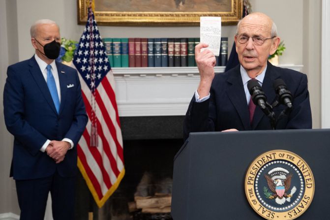 Breyer holds up a copy of the Constitution as he <a href="index.php?page=&url=https%3A%2F%2Fwww.cnn.com%2F2022%2F01%2F27%2Fpolitics%2Fbiden-breyer-announcement%2Findex.html" target="_blank">announces his retirement</a> alongside President Joe Biden in January 2022. In a brief speech that recounted historical figures from the nation's past, including Abraham Lincoln and George Washington, Breyer thanked the President, reflected on his time on the high court and expressed optimism about the future of the country.