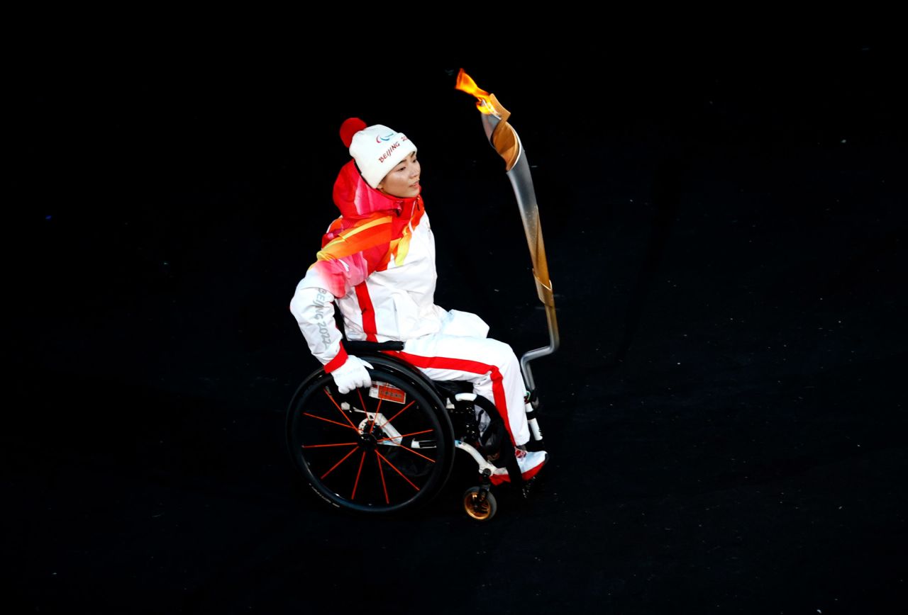 A torchbearer carries the Olympic flame.