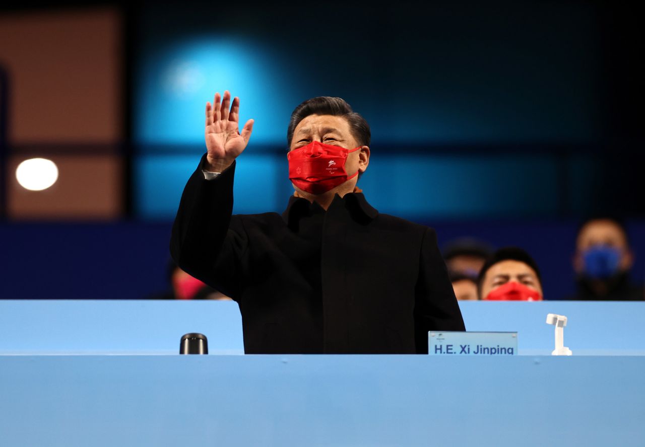 Chinese President Xi Jinping waves during the opening ceremony.