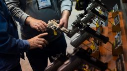 NRA members are seen examining handguns and other merchandise during an exhibition in Indianapolis, Indiana.