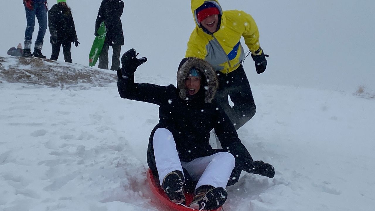 When a blizzard hit Denver, the mother and son went sledding on a hill near their house.
