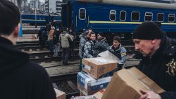People form a human chain to transfer supplies on March 3, 2022, in Kyiv, Ukraine.