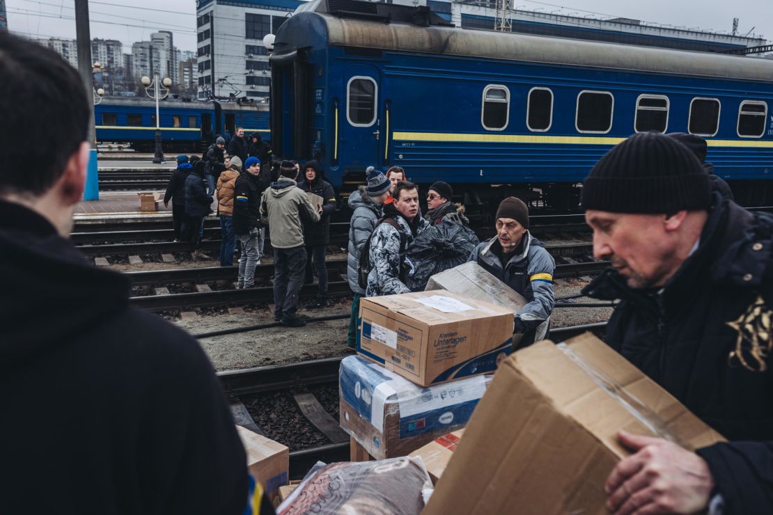 People form a human chain to transfer supplies on Thursday in Kyiv, Ukraine. 