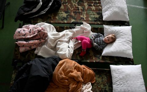 A Ukrainian child rests on a bed at a temporary refugee center in Záhony, Hungary, on March 4.
