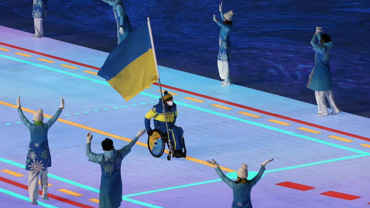 Flag bearer Maksym Yarovyi leads out Team Ukraine during the Opening Ceremony of the Beijing 2022 Winter Paralympics.