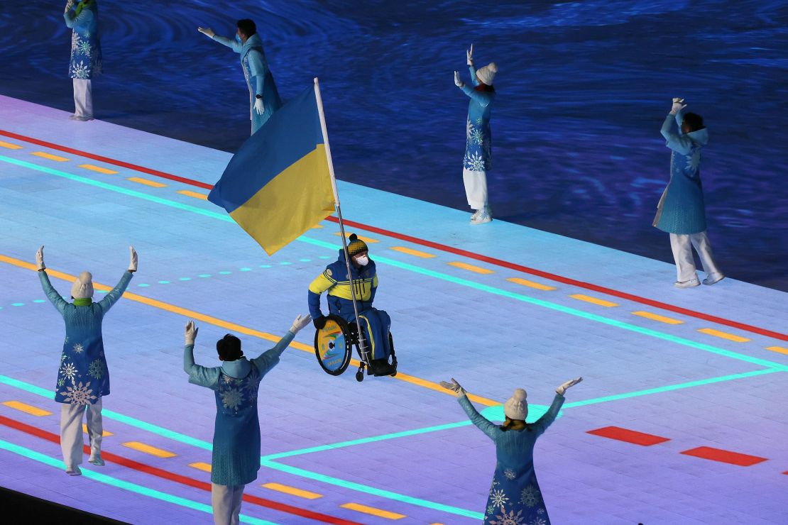 Flag bearer Maksym Yarovyi leads out Team Ukraine during the Opening Ceremony of the Beijing 2022 Winter Paralympics.