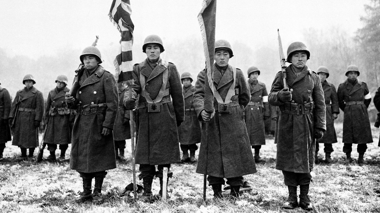 Members of the Japanese-American 442nd Infantry Regiment stand at attention while their citations are read in France  on November 12, 1944, during World War II.