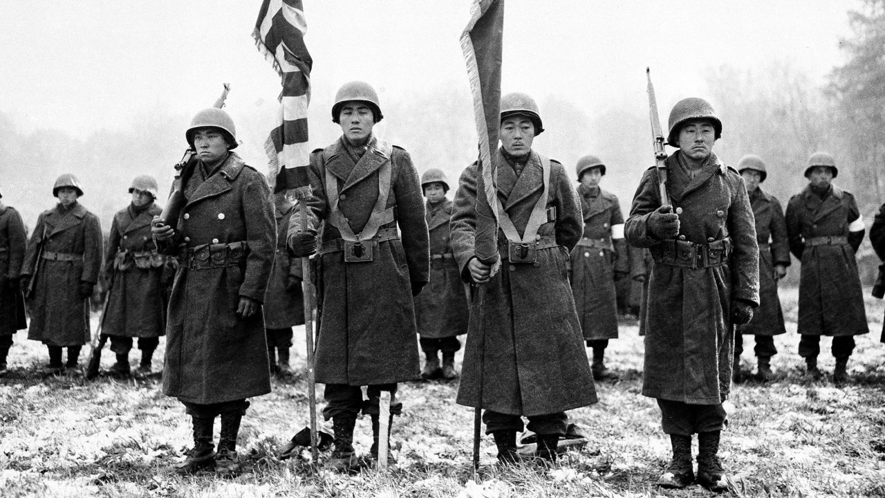 Members of the Japanese-American 442nd Infantry Regiment stand at attention while their citations are read in France on November 12, 1944, during World War II.