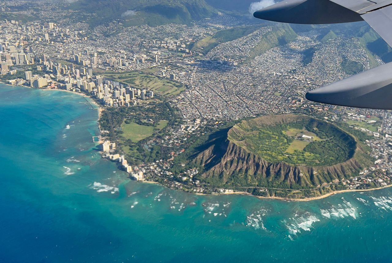 An aerial view from the window of a plane shows Diamond Head crater in Oahu. Hawaii is lifting some Covid restrictions later this month.