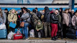 People crowd on the platform as they try to get on a train to Lviv at the main train station in Kyiv, Ukraine, Friday, March 4. 2022. Ukrainian men have to stay to fight in the war while women and children are leaving the country to seek refuge in a neighboring country.