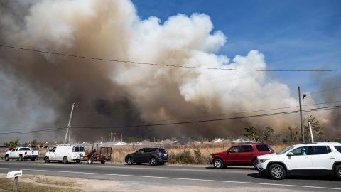 Traffic crawled to a stop Friday on Transmitter Road as fire loomed in the background. 