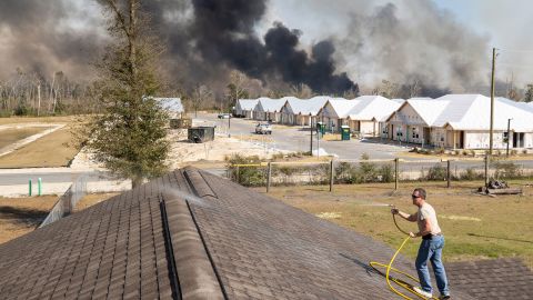 David Watson climbed to the roof of his home to keep embers from igniting a fire.