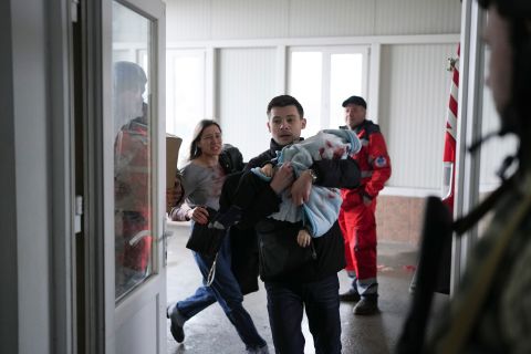 Marina Yatsko runs behind her boyfriend, Fedor, as they arrive at the hospital with her 18-month-old son, Kirill, who was wounded by shelling in Mariupol on March 4. Medical workers frantically tried to save the boy's life, but he didn't survive.