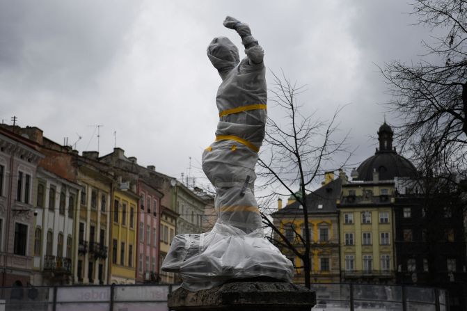 A statue is covered in Lviv on March 5. <a href="index.php?page=&url=https%3A%2F%2Fwww.cnn.com%2Fstyle%2Farticle%2Flviv-ukraine-statues-wrapped-heritage-protection%2Findex.html" target="_blank">Residents wrapped statues</a> in protective sheets to try to safeguard historic monuments across the city.