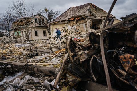 Local residents help clear the rubble of a home that was destroyed by a suspected Russian airstrike in Markhalivka, Ukraine, on March 5.