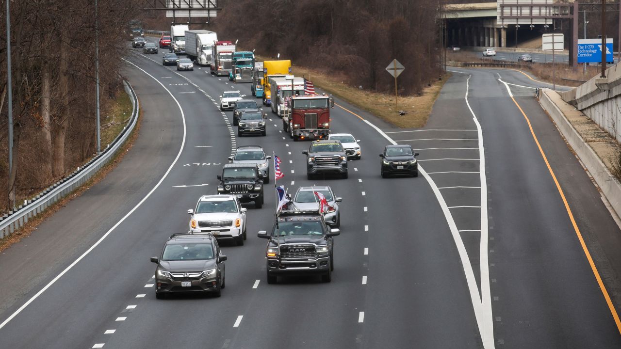 A convoy of trucks and other vehicles exit onto Interstate 495 to drive around the Washington beltway from Bethesda, Maryland, on Sunday, March 6, 2022. 