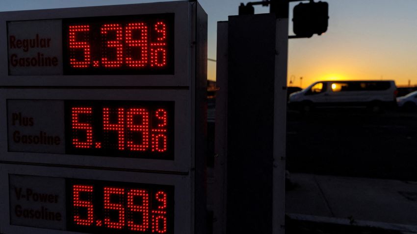 Traffic moves past a sign displaying current gas prices in San Diego, on February 28, 2022.