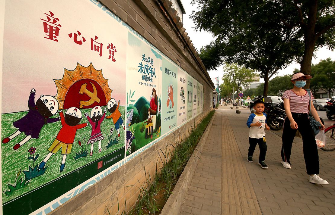 Mandatory Credit: Photo by Stephen Shaver/UPI/Shutterstock (12220860a)
Chinese walk past a Communist Party mural extolling the benefits provided to children by the Party in Beijing, on Sunday, July 18, 2021.  China's Soviet Union-style posters and slogans have begun a propaganda campaign to promote the country's new three-child policy.
Propaganda Poster Adorns a Public Wall in Beijing, China - 18 Jul 2021