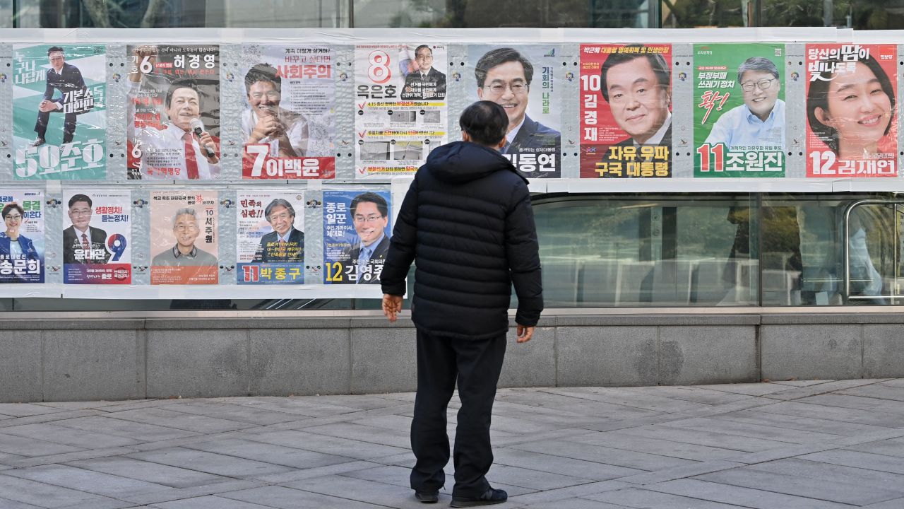 A man looks at election posters in Seoul, South Korea, ahead of the March 9 presidential election. 