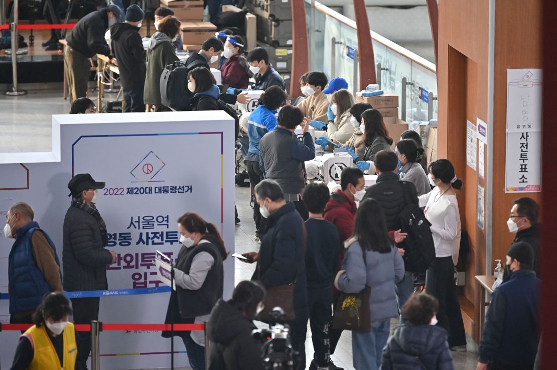 People cast their ballots during early voting South Korea's presidential election at a polling station in Seoul on March 4.